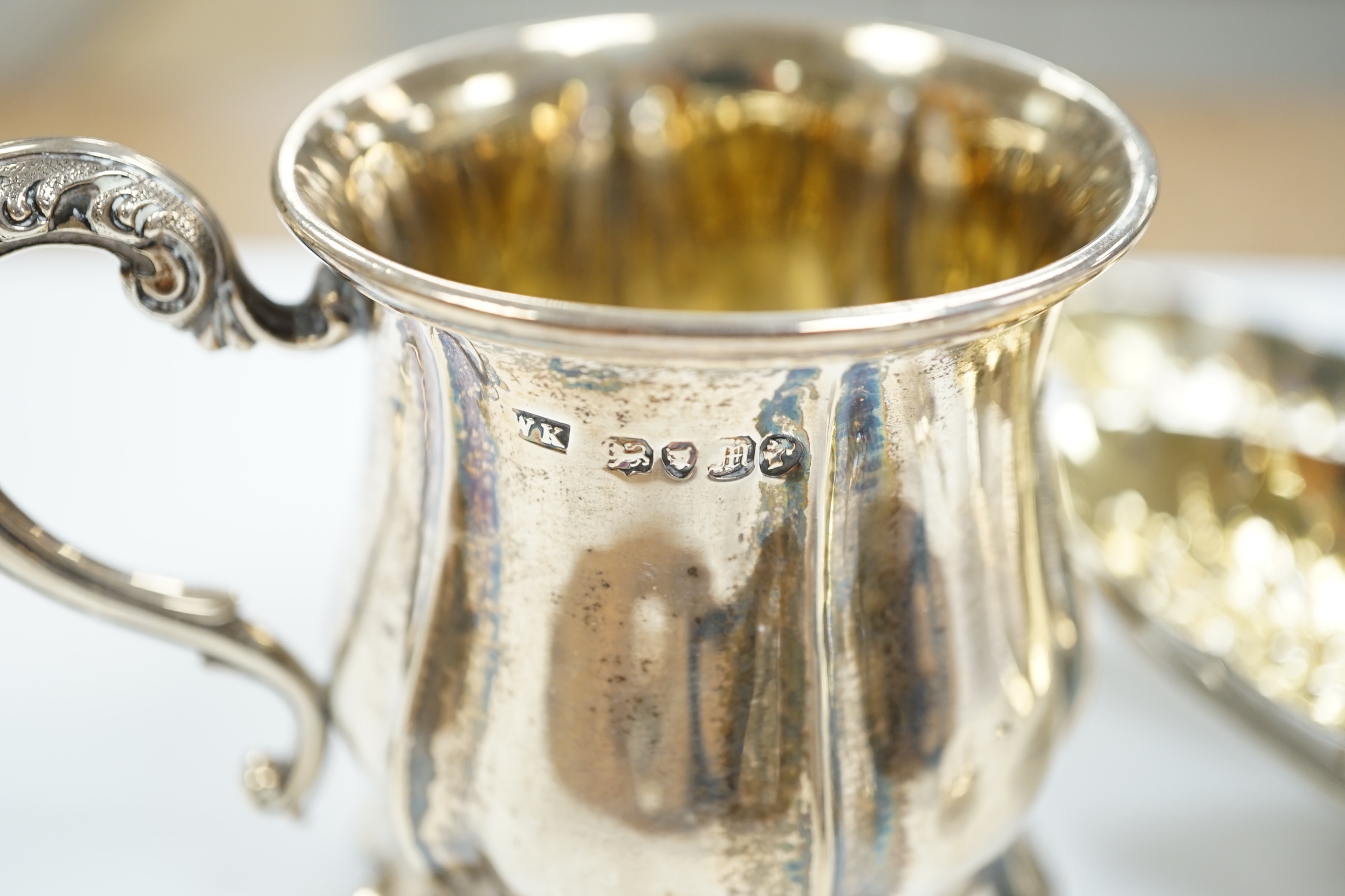 An Edwardian silver 'anointing spoon' Wakeley & Wheeler, London, 1901, 25.5cm, eight other silver spoons including two 19th century caddy spoons and a silver christening mug, 17.7oz.